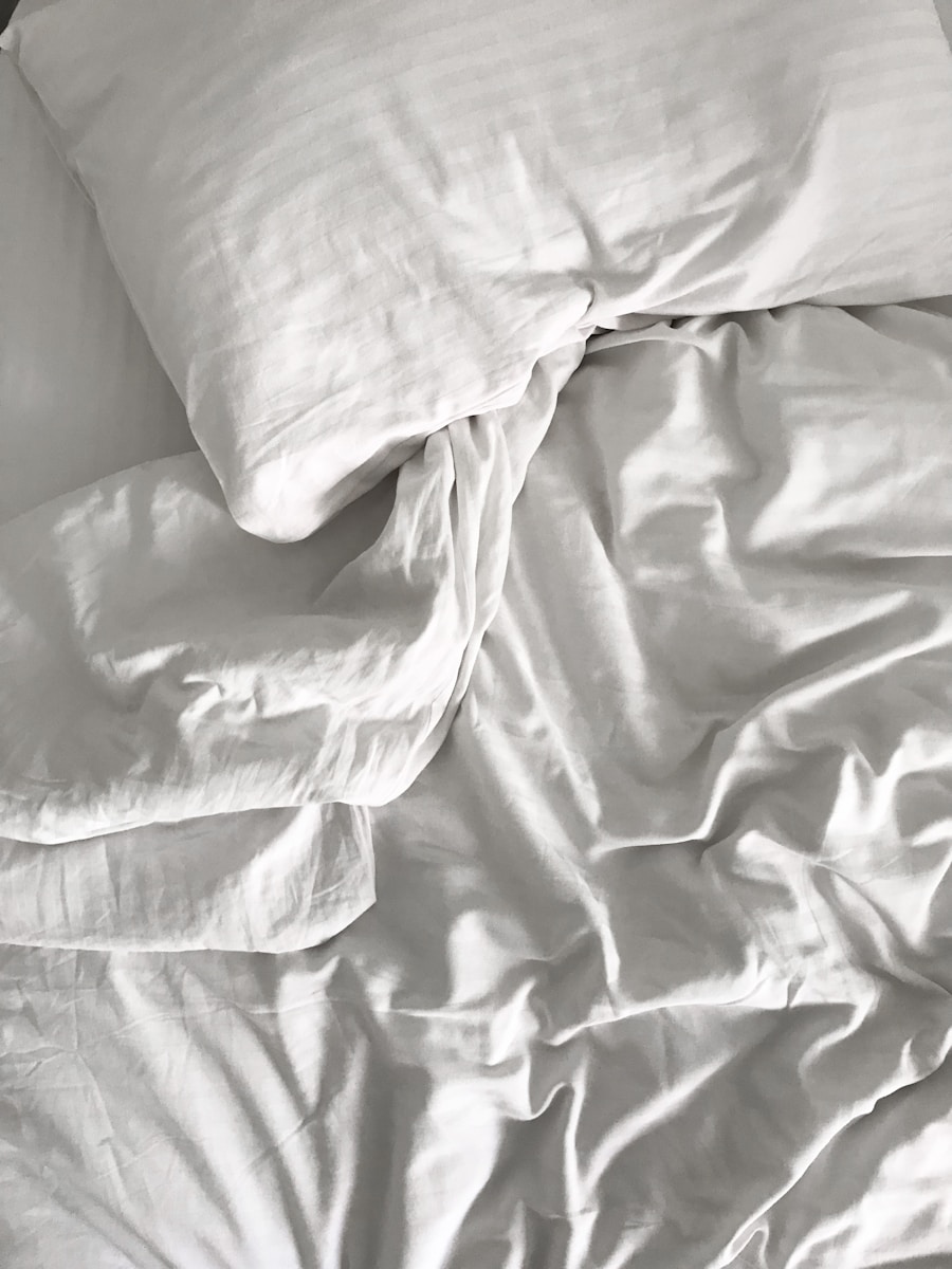 an unmade bed with white sheets and pillows. Chronic Pain Sleep Insights.